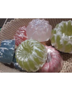Handmade glycerin soaps inside decorated with seasells and poppy seed in flat round shape
