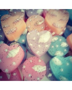 Handmade glycerin soaps inside decorated with dried orange and poppy seed in  heart shape 